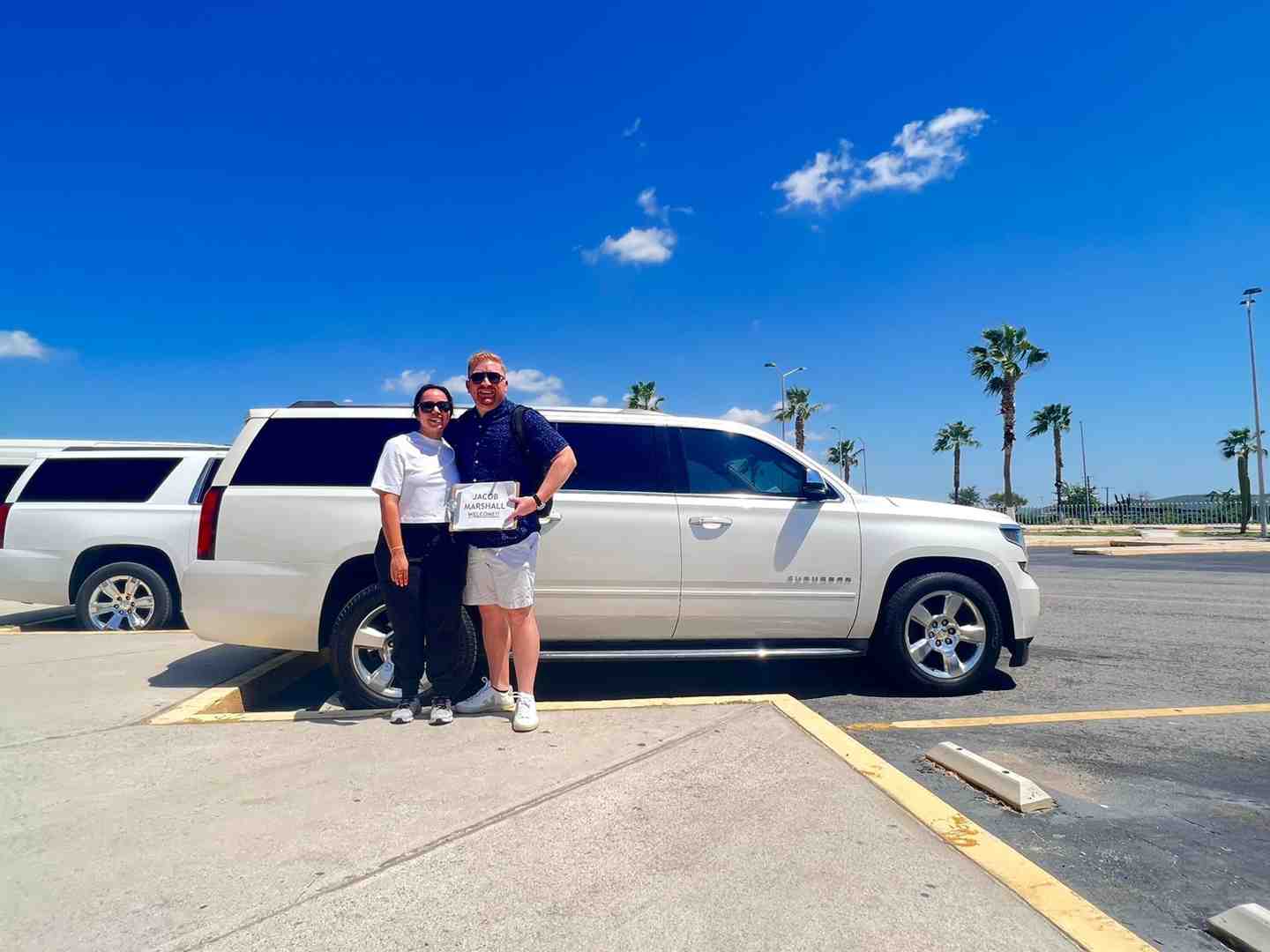 Smiling family getting into SJD Taxi private SUV - car rentals los cabos