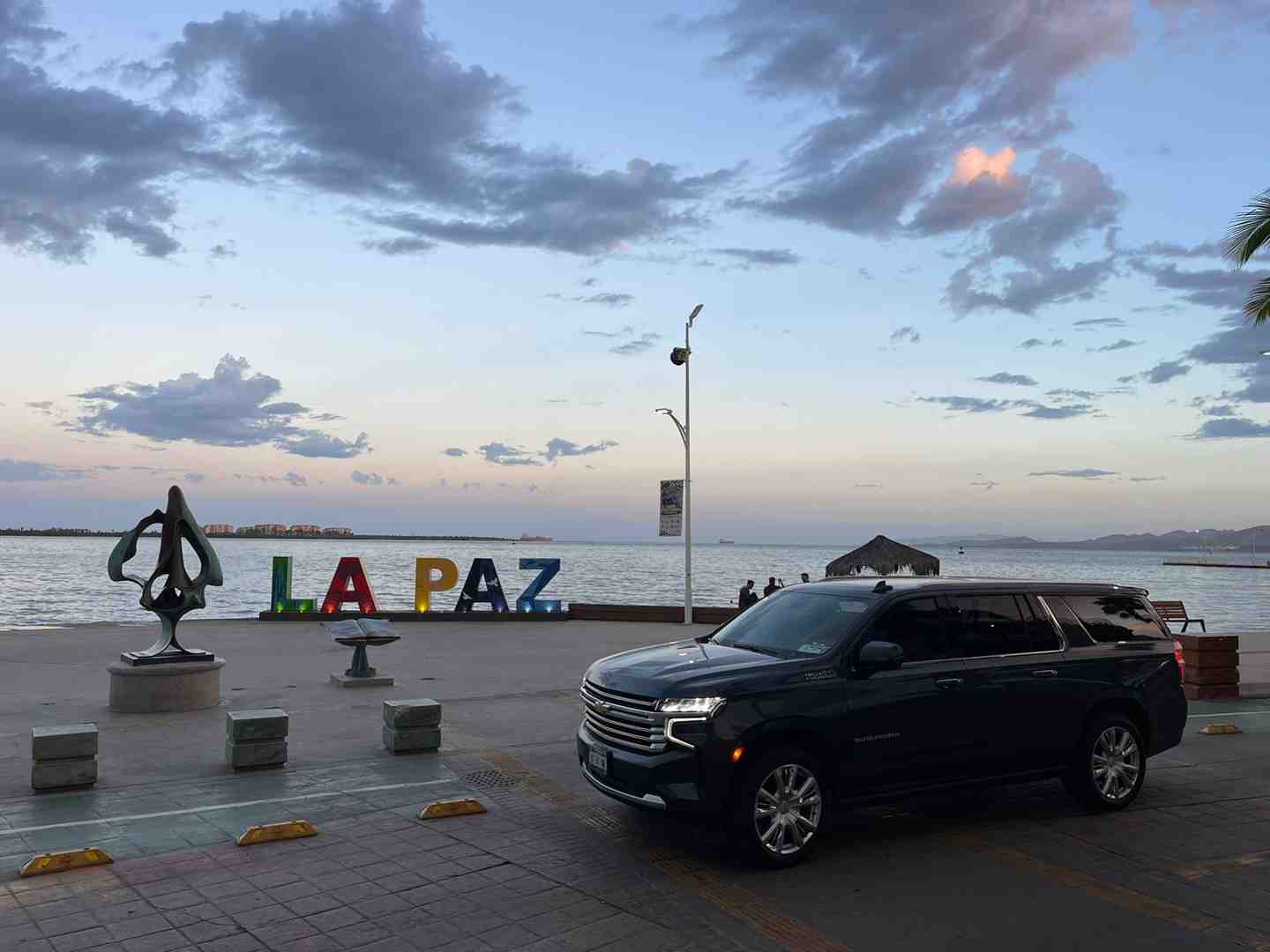 A car driving along the scenic coast near La Paz - La Paz airport transportation