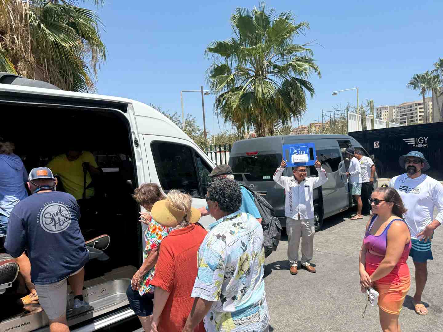 Image of a family happily loading into a private van for a day trip - cabo san lucas private driver Image of a family happily loading into a private van for a day trip - cabo san lucas private driver