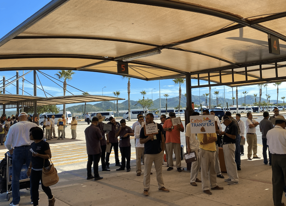 designated SJD Taxi shuttle pickup area with umbrellas at SJD airport - Shuttle SJD to Cabo San Lucas